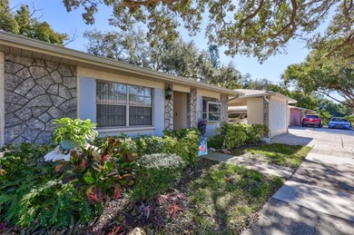 This end unit villa is right next to the covered carport and on Highland Lakes Executive Golf Course in Florida - for sale on GolfHomes.com, golf home, golf lot