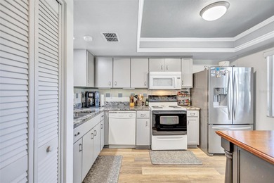 This end unit villa is right next to the covered carport and on Highland Lakes Executive Golf Course in Florida - for sale on GolfHomes.com, golf home, golf lot