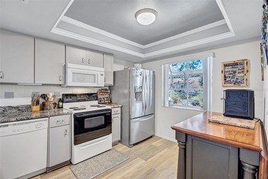 This end unit villa is right next to the covered carport and on Highland Lakes Executive Golf Course in Florida - for sale on GolfHomes.com, golf home, golf lot