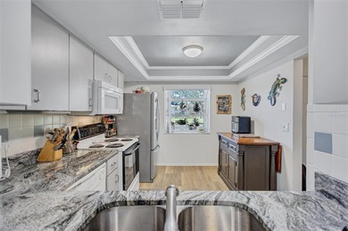 This end unit villa is right next to the covered carport and on Highland Lakes Executive Golf Course in Florida - for sale on GolfHomes.com, golf home, golf lot