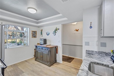 This end unit villa is right next to the covered carport and on Highland Lakes Executive Golf Course in Florida - for sale on GolfHomes.com, golf home, golf lot