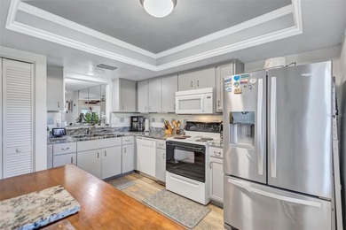 This end unit villa is right next to the covered carport and on Highland Lakes Executive Golf Course in Florida - for sale on GolfHomes.com, golf home, golf lot