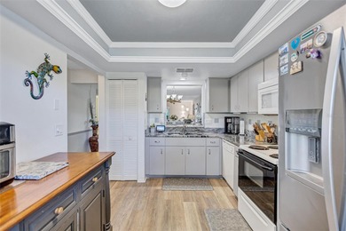 This end unit villa is right next to the covered carport and on Highland Lakes Executive Golf Course in Florida - for sale on GolfHomes.com, golf home, golf lot