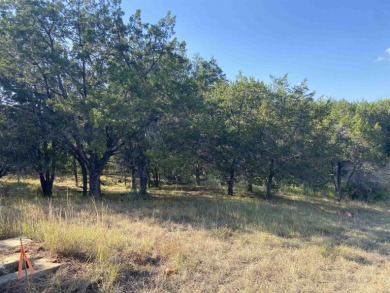 Don't miss out on this pretty wooded lot in Horseshoe Bay West on Apple Rock Golf Course - Horseshoe Bay in Texas - for sale on GolfHomes.com, golf home, golf lot