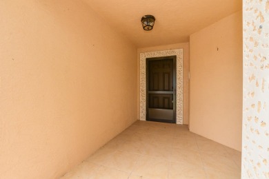 Very solid concrete block home with metal roof and accordion on Spanish Lakes I in Florida - for sale on GolfHomes.com, golf home, golf lot