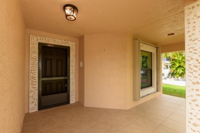 Very solid concrete block home with metal roof and accordion on Spanish Lakes I in Florida - for sale on GolfHomes.com, golf home, golf lot