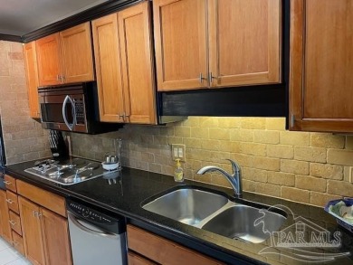 This beautifully furnished, wheelchair-accessible corner unit on on Pensacola Country Club in Florida - for sale on GolfHomes.com, golf home, golf lot