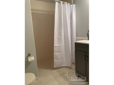 This beautifully furnished, wheelchair-accessible corner unit on on Pensacola Country Club in Florida - for sale on GolfHomes.com, golf home, golf lot