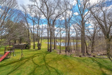 This fantastic home overlooks the 14th green of Lake Cora Hills on Lake Cora Hills Golf Club in Michigan - for sale on GolfHomes.com, golf home, golf lot