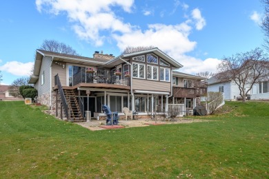 This fantastic home overlooks the 14th green of Lake Cora Hills on Lake Cora Hills Golf Club in Michigan - for sale on GolfHomes.com, golf home, golf lot