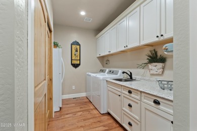 Discover timeless elegance and serene lake views in this on Pinetop Lakes Country Club in Arizona - for sale on GolfHomes.com, golf home, golf lot