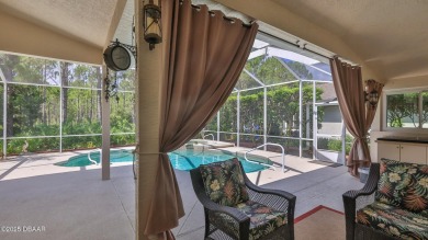 Discover the Florida lifestyle in this pool home-offered on Plantation Bay Golf and Country Club in Florida - for sale on GolfHomes.com, golf home, golf lot