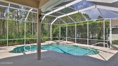 Discover the Florida lifestyle in this pool home-offered on Plantation Bay Golf and Country Club in Florida - for sale on GolfHomes.com, golf home, golf lot