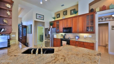Discover the Florida lifestyle in this pool home-offered on Plantation Bay Golf and Country Club in Florida - for sale on GolfHomes.com, golf home, golf lot