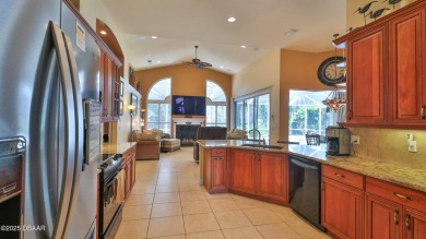 Discover the Florida lifestyle in this pool home-offered on Plantation Bay Golf and Country Club in Florida - for sale on GolfHomes.com, golf home, golf lot