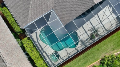 Discover the Florida lifestyle in this pool home-offered on Plantation Bay Golf and Country Club in Florida - for sale on GolfHomes.com, golf home, golf lot