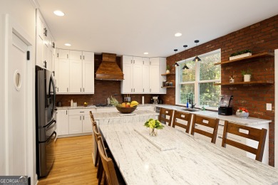 Price to move, this custom-built home sits on a roundabout on Hampton Golf Village in Georgia - for sale on GolfHomes.com, golf home, golf lot