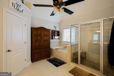Price to move, this custom-built home sits on a roundabout on Hampton Golf Village in Georgia - for sale on GolfHomes.com, golf home, golf lot