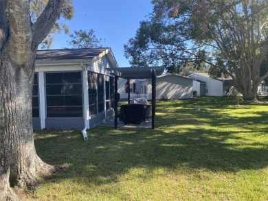 Outstanding one-story home with a screened porch and a beautiful on Plantation Golf Club in Florida - for sale on GolfHomes.com, golf home, golf lot