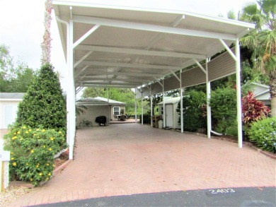 Located on an oversized corner property in the 55+ Regal Pointe on Deer Creek RV Golf Resort in Florida - for sale on GolfHomes.com, golf home, golf lot
