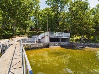 Welcome to 32280 Gliding Hawk, where modern luxury meets serene on Indian Rock Golf Club in Missouri - for sale on GolfHomes.com, golf home, golf lot