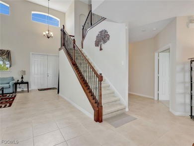 Discover exceptional living in this stunning two-story residence on Valencia Golf and Country Club in Florida - for sale on GolfHomes.com, golf home, golf lot