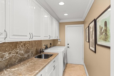 Enjoy lakefront sunsets from this elegant home in the gated on Greenview Cove Golf Club in Florida - for sale on GolfHomes.com, golf home, golf lot