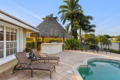 Enjoy lakefront sunsets from this elegant home in the gated on Greenview Cove Golf Club in Florida - for sale on GolfHomes.com, golf home, golf lot