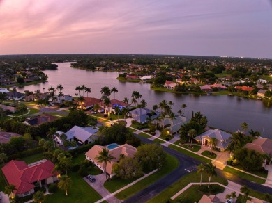 Enjoy lakefront sunsets from this elegant home in the gated on Greenview Cove Golf Club in Florida - for sale on GolfHomes.com, golf home, golf lot