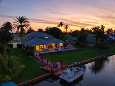 Enjoy lakefront sunsets from this elegant home in the gated on Greenview Cove Golf Club in Florida - for sale on GolfHomes.com, golf home, golf lot