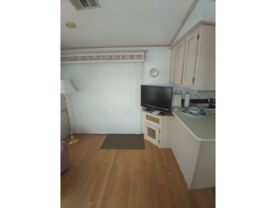 Furnished Park Model on large corner lot with shed and spacious on Deer Creek RV Golf Resort in Florida - for sale on GolfHomes.com, golf home, golf lot