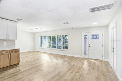 Nestled on a desirable corner lot in Feather Sound, this fully on Feather Sound Country Club in Florida - for sale on GolfHomes.com, golf home, golf lot