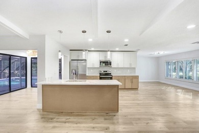 Nestled on a desirable corner lot in Feather Sound, this fully on Feather Sound Country Club in Florida - for sale on GolfHomes.com, golf home, golf lot