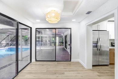 Nestled on a desirable corner lot in Feather Sound, this fully on Feather Sound Country Club in Florida - for sale on GolfHomes.com, golf home, golf lot