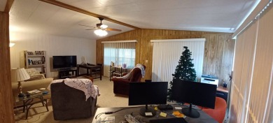 Come settle down and relax in a beautiful, manufactured home on Fairways Country Club in Florida - for sale on GolfHomes.com, golf home, golf lot