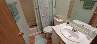 Come settle down and relax in a beautiful, manufactured home on Fairways Country Club in Florida - for sale on GolfHomes.com, golf home, golf lot