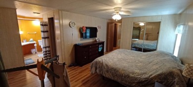 Come settle down and relax in a beautiful, manufactured home on Fairways Country Club in Florida - for sale on GolfHomes.com, golf home, golf lot