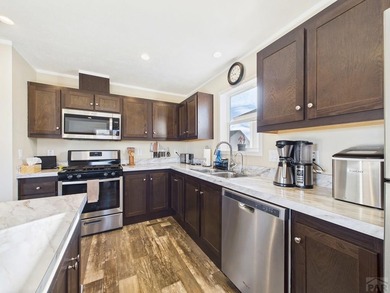 This well-maintained 3-bedroom, 2-bathroom manufactured home on Hollydot Golf Course in Colorado - for sale on GolfHomes.com, golf home, golf lot