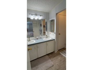 This move-in-ready gem has 2 bedrooms, 2 baths, and is located on Sabal Springs Golf and Racquet Club in Florida - for sale on GolfHomes.com, golf home, golf lot