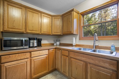 This beautifully designed home offers the perfect blend of on Michaywe Pines Course in Michigan - for sale on GolfHomes.com, golf home, golf lot