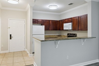 Enjoy vacationing, or living in this first floor condo that on ChampionsGate Golf Resort in Florida - for sale on GolfHomes.com, golf home, golf lot