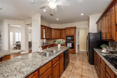 Let the golf cart paths welcome you to this refined single-story on Stonebridge Ranch Country Club in Texas - for sale on GolfHomes.com, golf home, golf lot