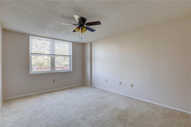 Perched on the top floor of Crystal Bay, this fourth-story condo on Feather Sound Country Club in Florida - for sale on GolfHomes.com, golf home, golf lot