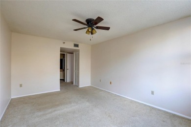 Perched on the top floor of Crystal Bay, this fourth-story condo on Feather Sound Country Club in Florida - for sale on GolfHomes.com, golf home, golf lot