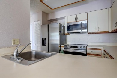 Perched on the top floor of Crystal Bay, this fourth-story condo on Feather Sound Country Club in Florida - for sale on GolfHomes.com, golf home, golf lot