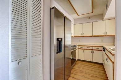 Perched on the top floor of Crystal Bay, this fourth-story condo on Feather Sound Country Club in Florida - for sale on GolfHomes.com, golf home, golf lot