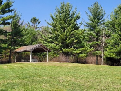 This natural 1+ wooded tranquil setting creates a perfect place on Northern Bay Golf Resort and Marina in Wisconsin - for sale on GolfHomes.com, golf home, golf lot