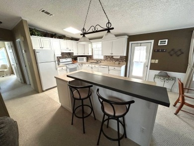 This bright home has been lovingly remodeled bringing modern on Crystal Lake Club in Florida - for sale on GolfHomes.com, golf home, golf lot