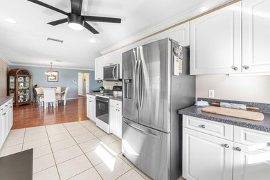 Enjoy easy Florida living in this well-cared-for 3-bedroom on Palm Beach National Golf and Country Club in Florida - for sale on GolfHomes.com, golf home, golf lot