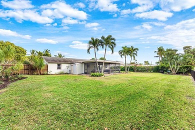 Enjoy easy Florida living in this well-cared-for 3-bedroom on Palm Beach National Golf and Country Club in Florida - for sale on GolfHomes.com, golf home, golf lot